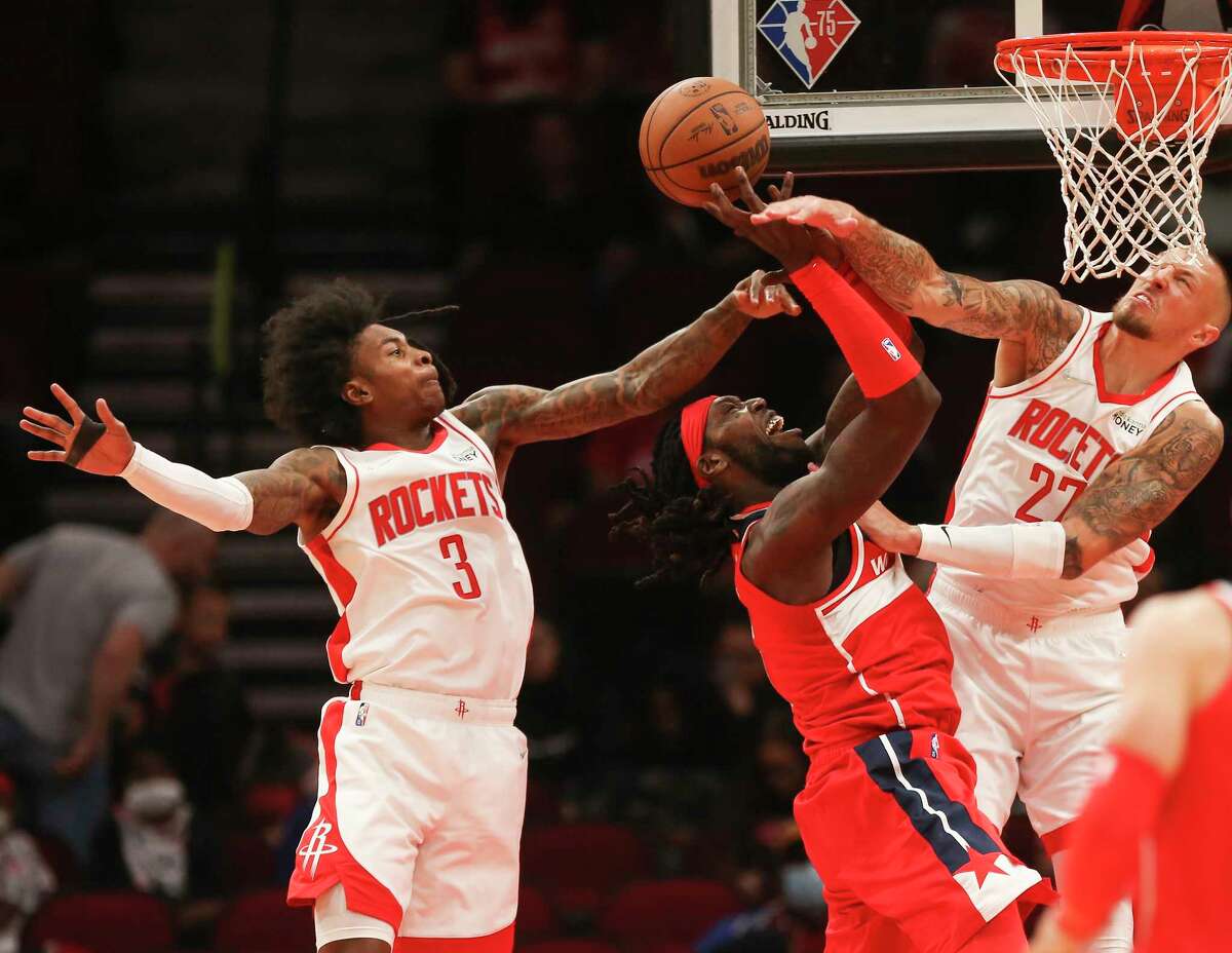 Houston Rockets center Daniel Theis (27) blocks Washington Wizards forward Montrezl Harrell (6) during the first half of the NBA game Tuesday, Oct. 5, 2021, at Toyota Center in Houston.