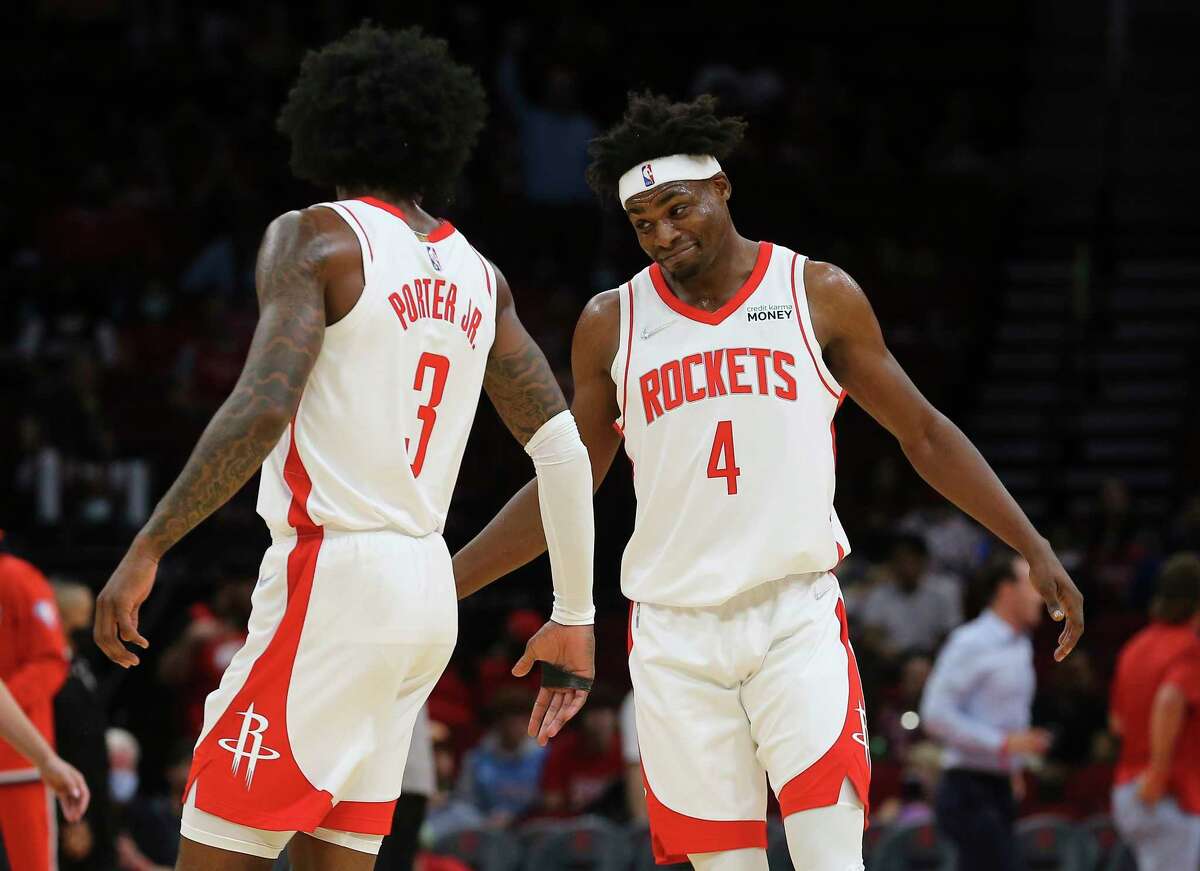 Houston Rockets players Kevin Porter Jr. (3) and Danuel House Jr. (4) celebrate a team score during the first quarter of the NBA game against the Washington Wizards Tuesday, Oct. 5, 2021, at Toyota Center in Houston.