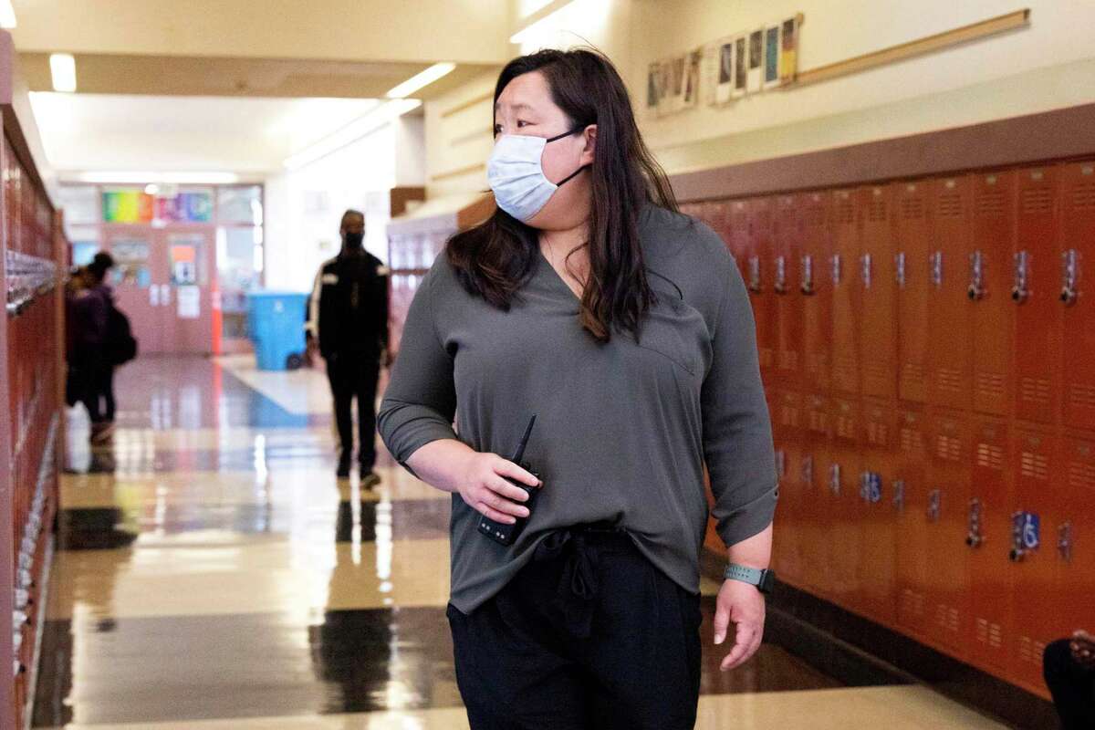 Counselor Leslie Hu walks the yard and checks in with students during lunchtime at Dr. Martin Luther King Jr. Academic Middle School in San Francisco. Hu is seeing the fallout from the pandemic play out on the playground and in classrooms.