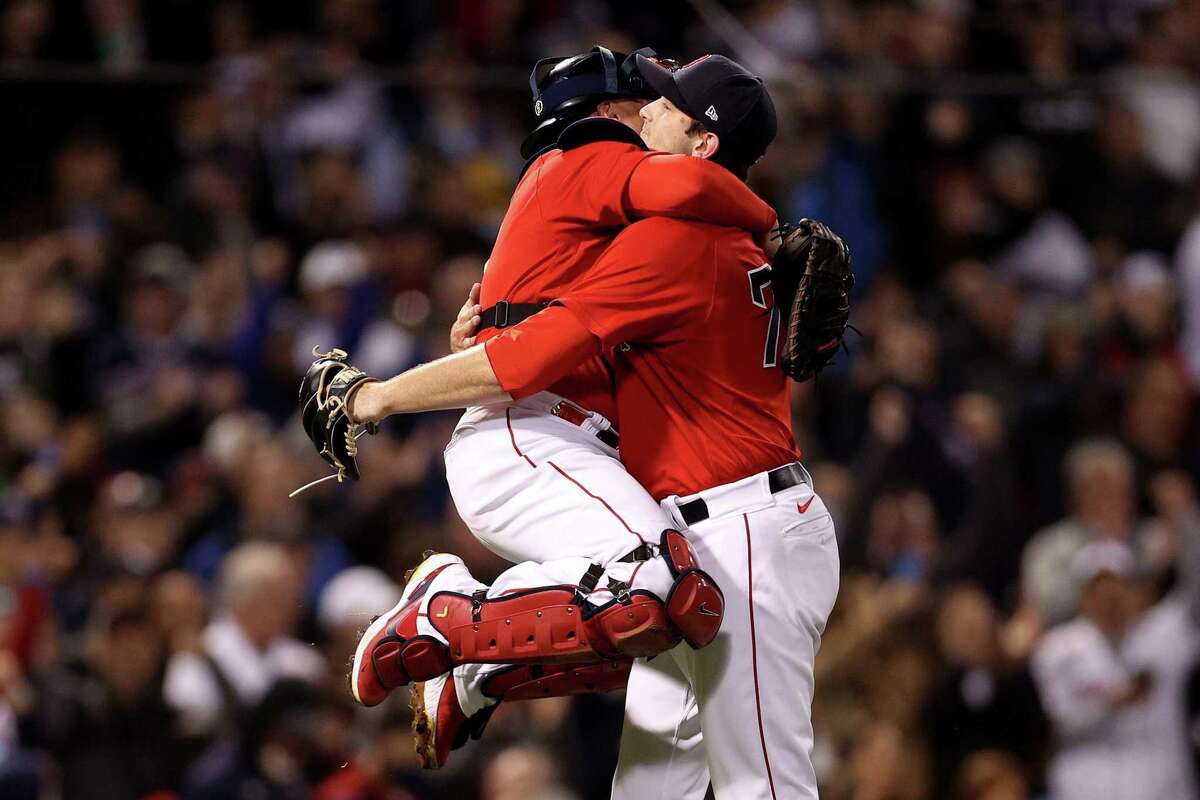 BOSTON, MASSACHUSETTS - OCTOBER 05: Garrett Whitlock #72 and Christian Vazquez #7 of the Boston Red Sox celebrate after beating the New York Yankees 6-2 in the American League Wild Card game at Fenway Park on October 05, 2021 in Boston, Massachusetts. (Photo by Maddie Meyer/Getty Images)