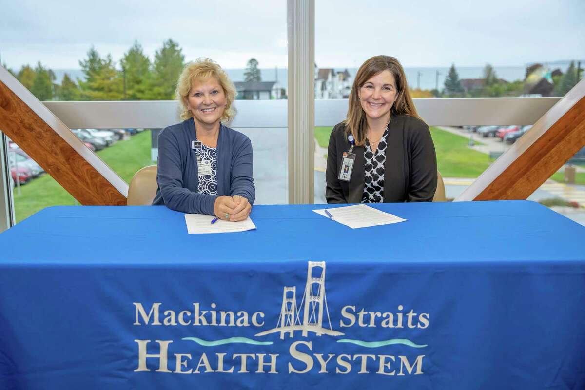 Mackinac Straits Health System (MSHS) and MidMichigan Health jointly announced a formal affiliation between the two organizations that will addressing technology (IT) and Electronic Medical Records (EMR) needs. Pictured during Monday's signing are (left to right): Diane Postler-Slattery, Ph.D., FACHE, president and CEO, MidMichigan Health, and Karen Cheeseman, president and CEO, MSHS. (Photo provided)