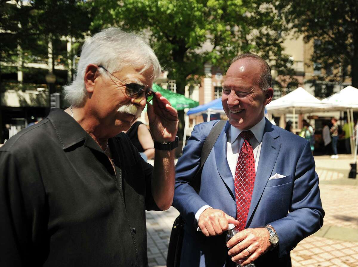 Jim Koplik, regional president of concert promoter Live Nation, left, and Howard Saffan, owner of SportsCenter of Connecticut, chat following the Harbor Yard Amphitheater announcement on McLevy Green in Bridgeport, Conn. on Thursday, August 10, 2017.