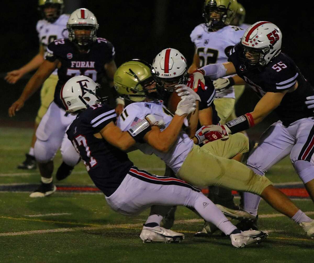 Jon Lahow (17) and Kyle Zarnoch (55) make the tackle for Foran in its victory over Barlow.