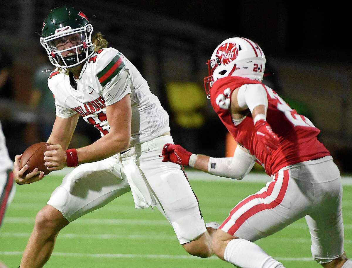 The Woodlands quarterback Mabrey Mettauer, left, tries to avoid the tackle of Katy linebacker Carson Marshall during the first half of a high school football game, Thursday, Sept. 16, 2021, in Katy.
