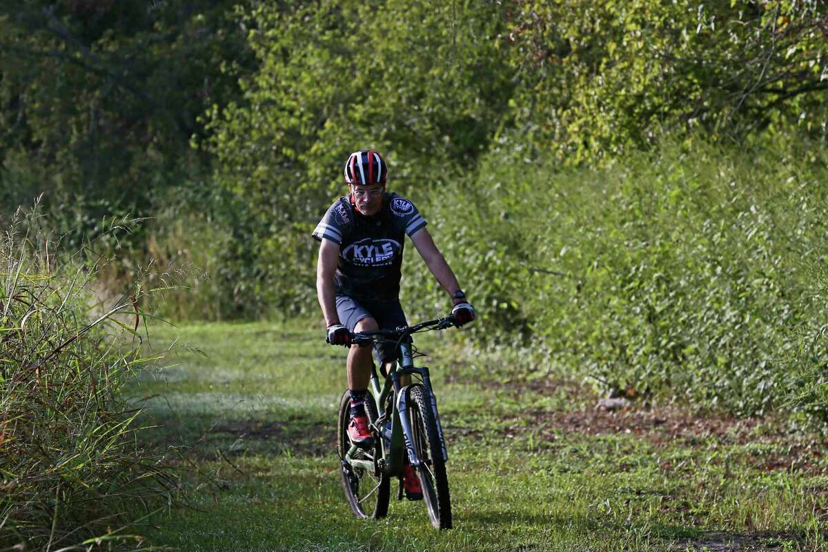 Cyclist James Stanfill, owner of Kyle Cyclery, rides the Plum Creek Park trail Monday in Kyle.