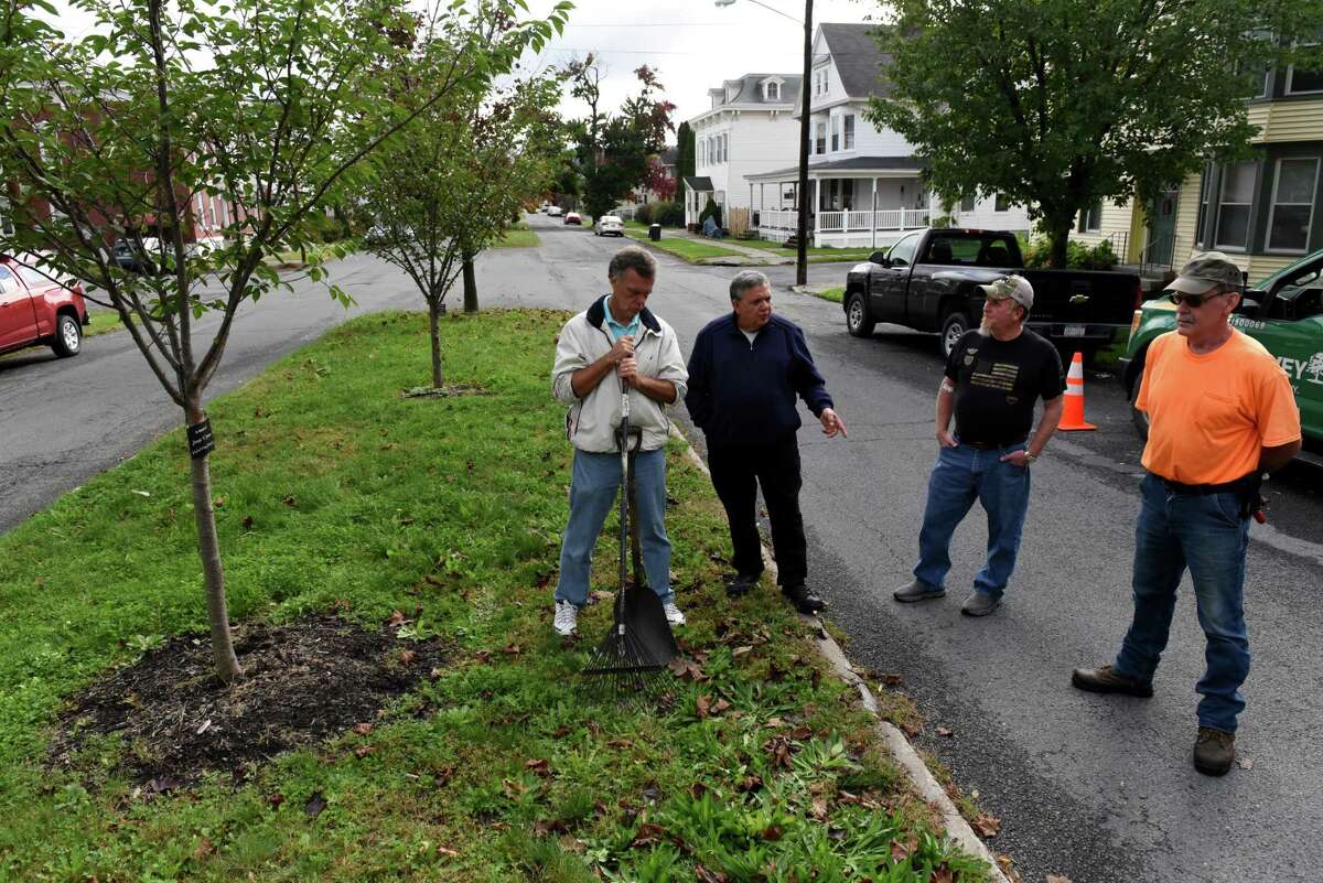 Watervliet tree committee member Bill Fahr, left, Mayor Charles Patricelli, Dan McGrath committee chairman and arborist, and Paul Fahr tree committee secretary, right, stand near some of the new trees planted by the city on 16th Street on Wednesday, Oct. 6, 2021, in Watervliet, N.Y. The city is conducting a city tree planting program.