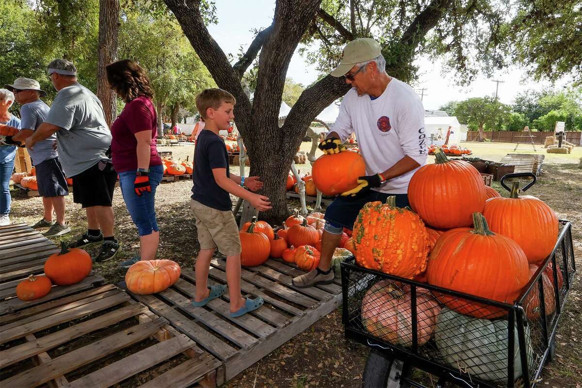 Micah Schaefer, 8, helps Frank Kenisky, right, stack pumpkins for the Universal City Pumpkin Patch at the Universal City Municipal Building on Sept. 27. This Saturday, Oct. 9 will be the patch’s Fall Fair, from 11 a.m. to 2 p.m. Several events are planned for the fair, including hay rides, a petting zoo and a pumpkin jump house.