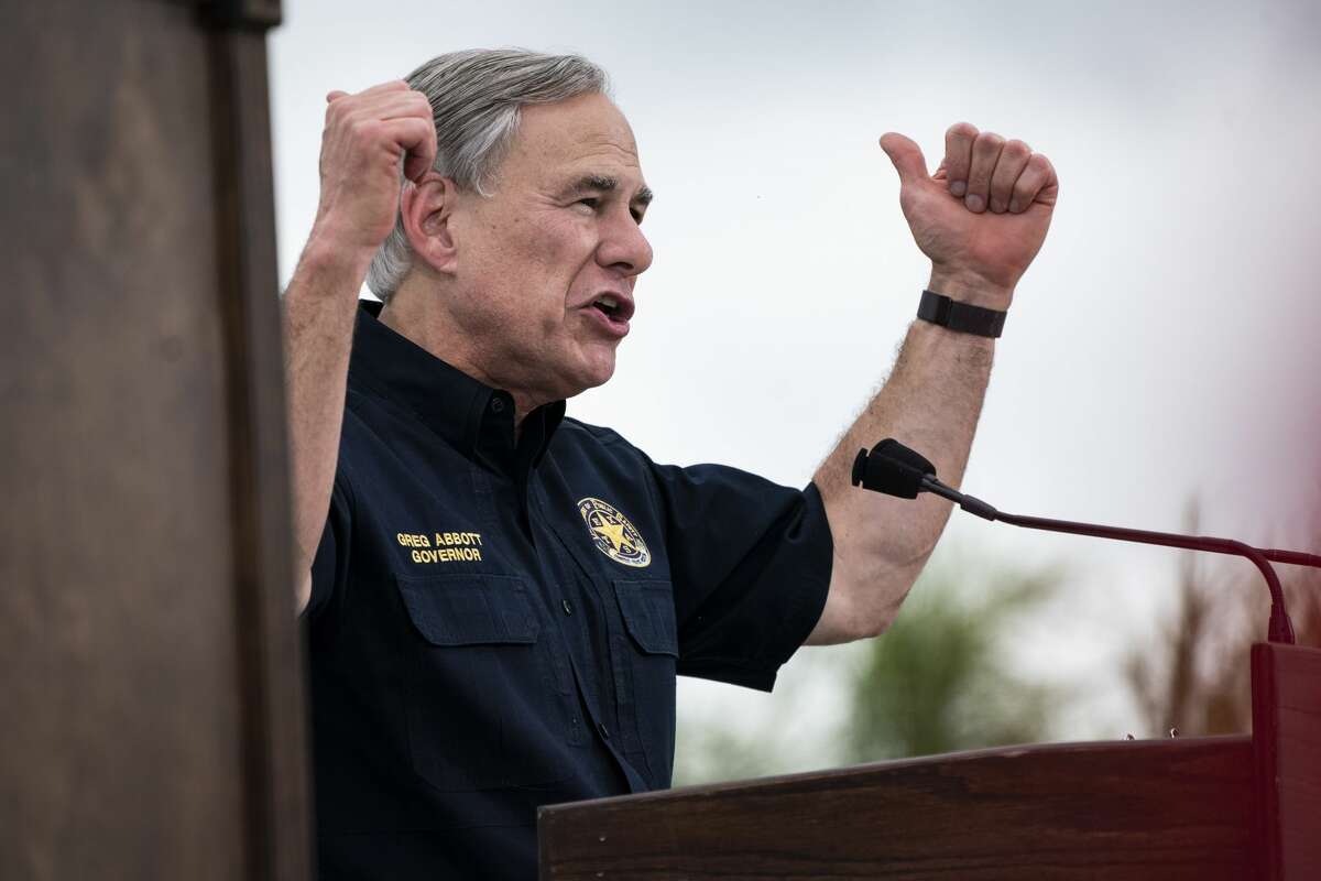 Texas Governor Greg Abbott speaks to former President Donald J. Trump as they speak during a tour of the US-Mexico border wall on Wednesday, June 30, 2021 in Pharr, TX.