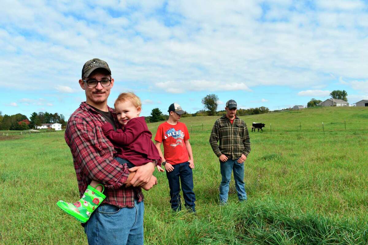 Brothers Sawyer, Scott and Jarrad Stilson help with work on their family farm which often includes upkeep of the farm's cows and being good role models for their younger sister Ina May. (Pioneer photo/Olivia Fellows)