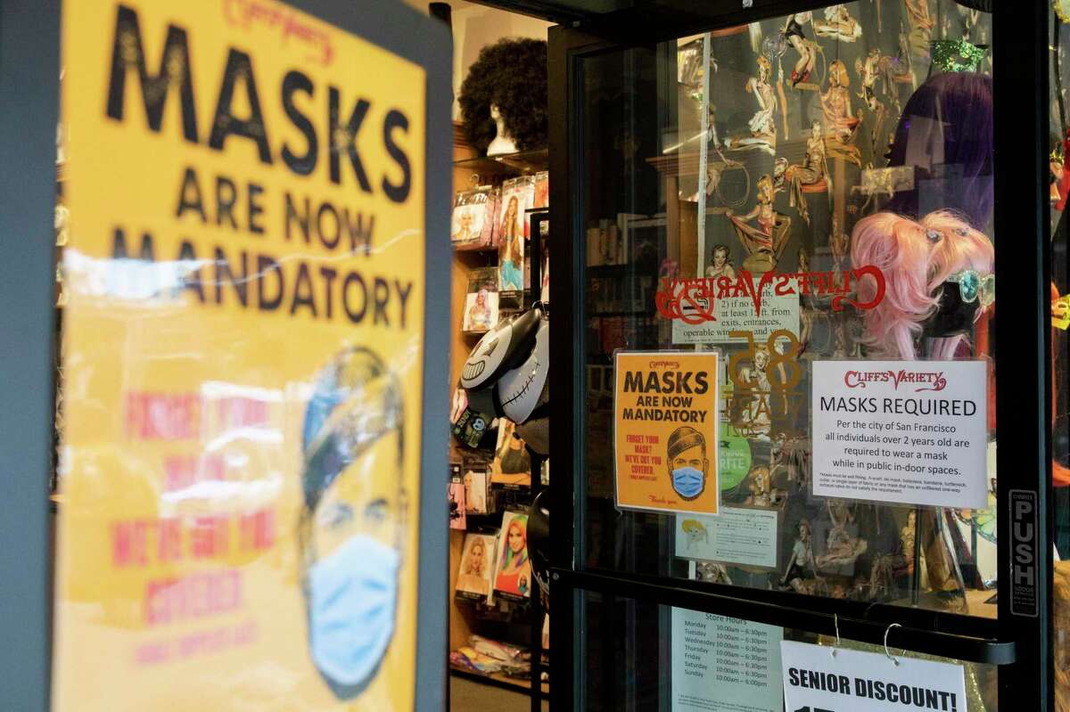 Signage reminds customers to wear face masks inside Cliff's Variety in San Francisco.  Co-owner Terry Asten Bennett said the city's mask tenure has helped it stay open and keep its staff and customers safe.