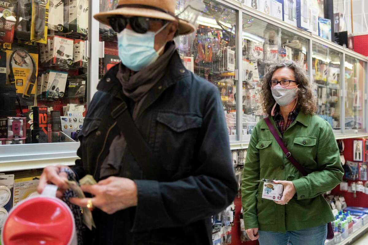 Customers wear masks while waiting in line for Cliff's Variety on Castro Street in San Francisco, California on Wednesday, October 6, 2021.