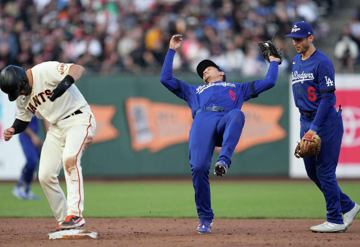 Corey Seager of the Los Angeles Dodgers falling backwards on the infield catches a popup off the bat of Steven Duggar of the San Francisco Giants in the bottom of the sixth inning at Oracle Park.