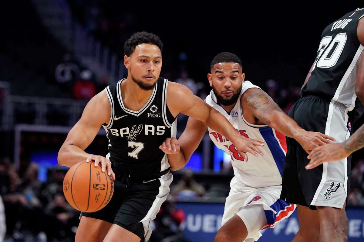 Spurs guard Bryn Forbes (7) drives on Pistons guard Cory Joseph during the first half of a preseason game on Wednesday, Oct. 6, 2021, in Detroit.