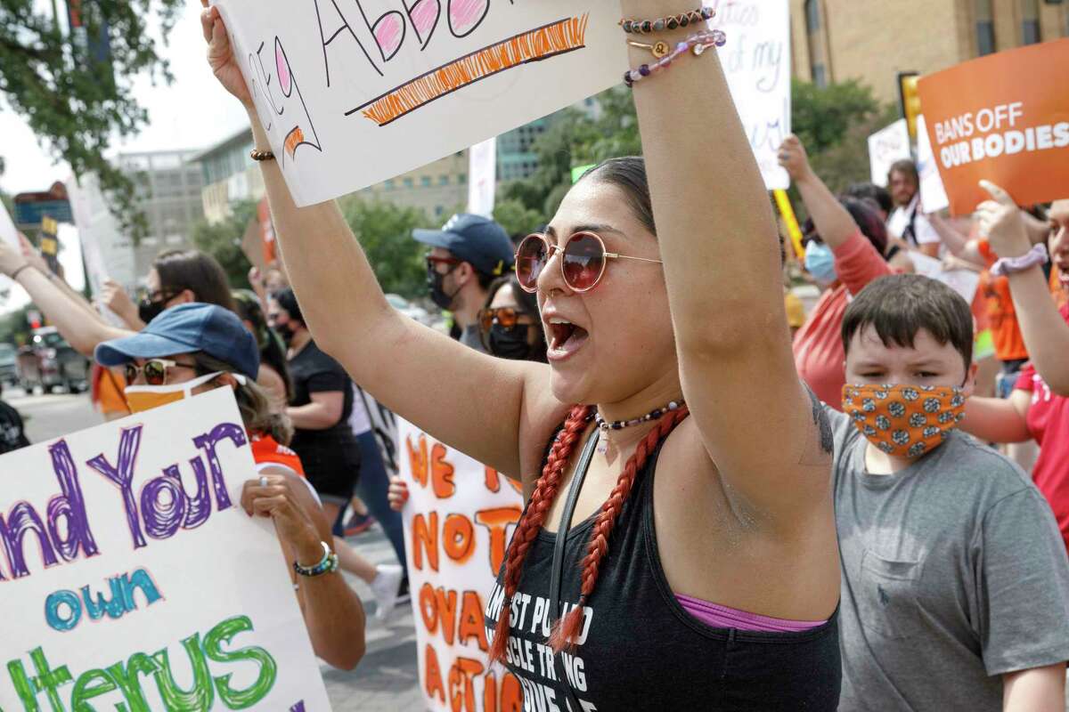 Lauren Flores chants along with other protesters as they march through downtown San Antonio, Texas, Saturday, Oct. 2, 2021, while participating in the “Ban Off Our Bodies” abortion rights march. It was one of more than 600 planned abortion rights marches taking place in cities across all 50 states Saturday afternoon.
