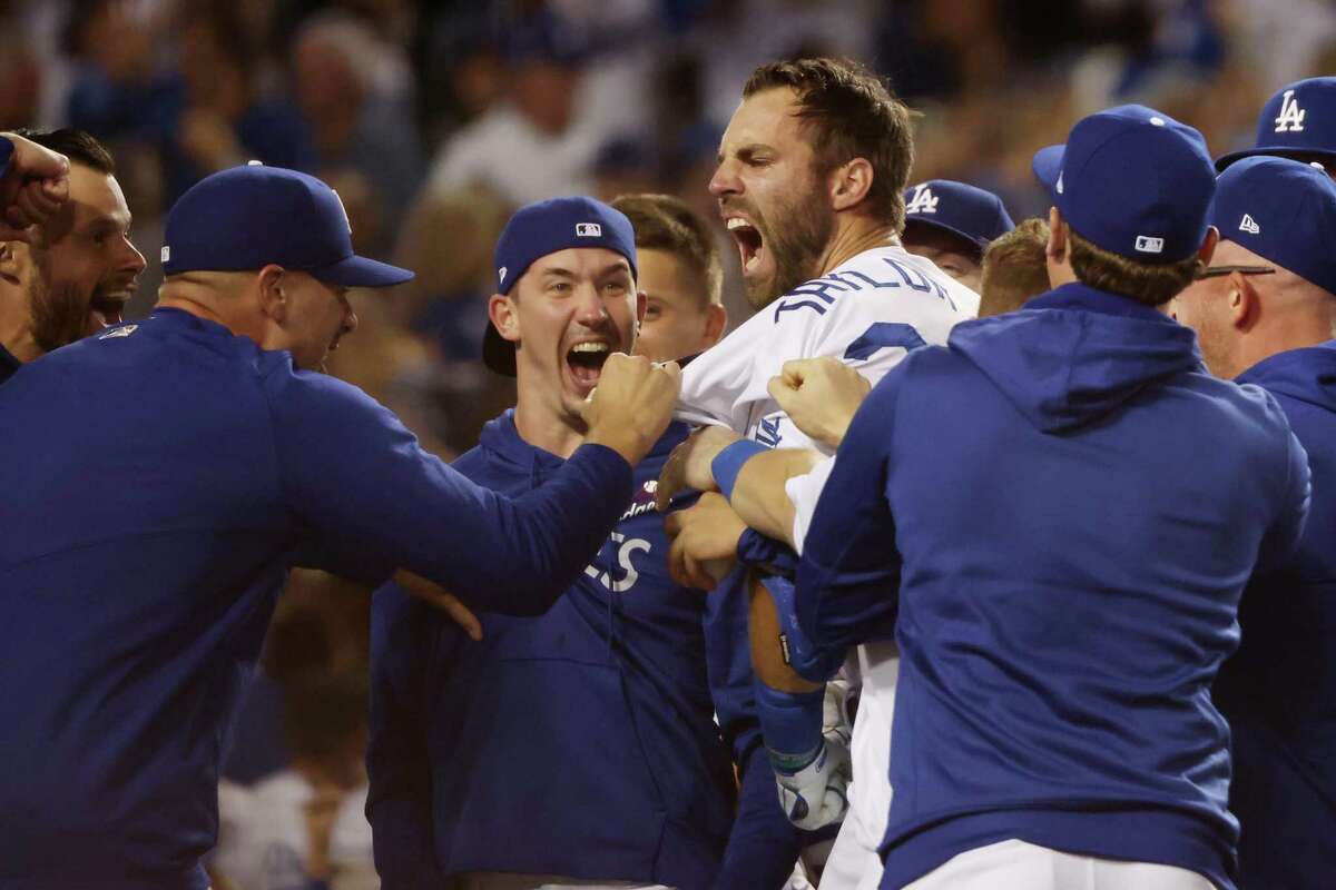 LOS ANGELES, CALIFORNIA - OCTOBER 06: Chris Taylor #3 of the Los Angeles Dodgers celebrates with teammates after his walk off two-run home run in the ninth inning to defeat the St. Louis Cardinals 3 to 1 during the National League Wild Card Game at Dodger Stadium on October 06, 2021 in Los Angeles, California. (Photo by Harry How/Getty Images)