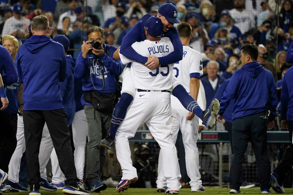 The Los Angeles Dodgers celebrate after Chris Taylor hit a home run in the ninth inning to win a National League Wild Card Playoff baseball game 3-1 against the St. Louis Cardinals on Wednesday, October 6, 2021, at Los Angeles.  Cody Bellinger also scored.