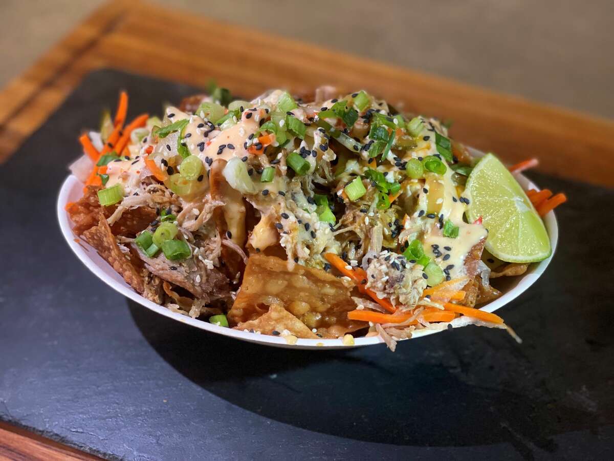 Minute Maid Park's Asian BBQ Nacho with fried wonton chips, glazed roasted pork, sweet chili aioli, teriyaki glaze, mint, cilantro, green onion and fresh lime.