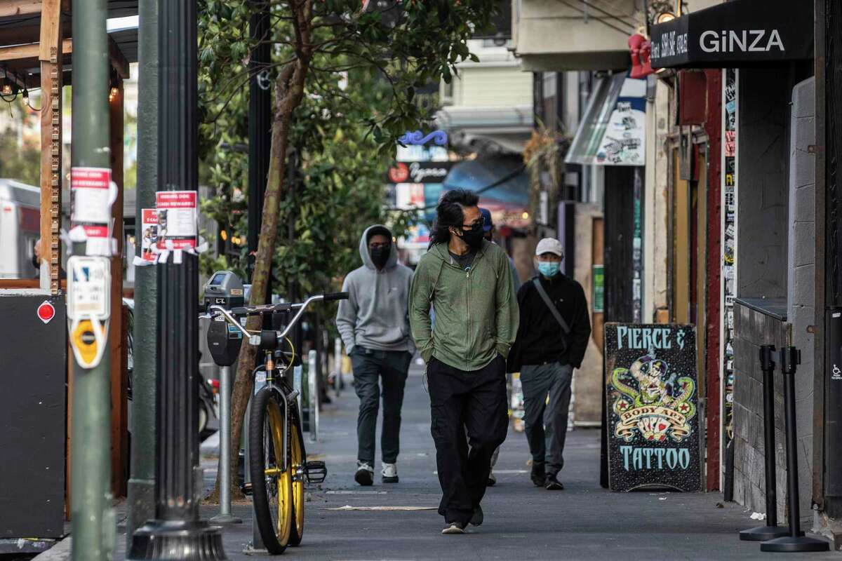 Many pedestrians on San Francisco’s Haight Street were masked on Wednesday. Masks are not required outdoors, and some indoor rules will ease on Oct. 15 in the city.
