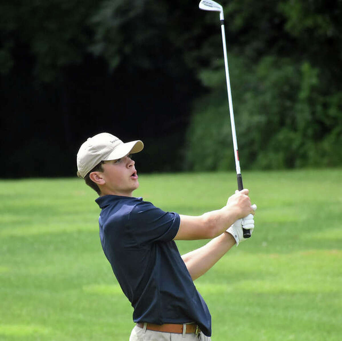 Father McGivney sophomore Joey Hyten watches his iron shot during the season-opening Hickory Stick Invitational at Belk Park.