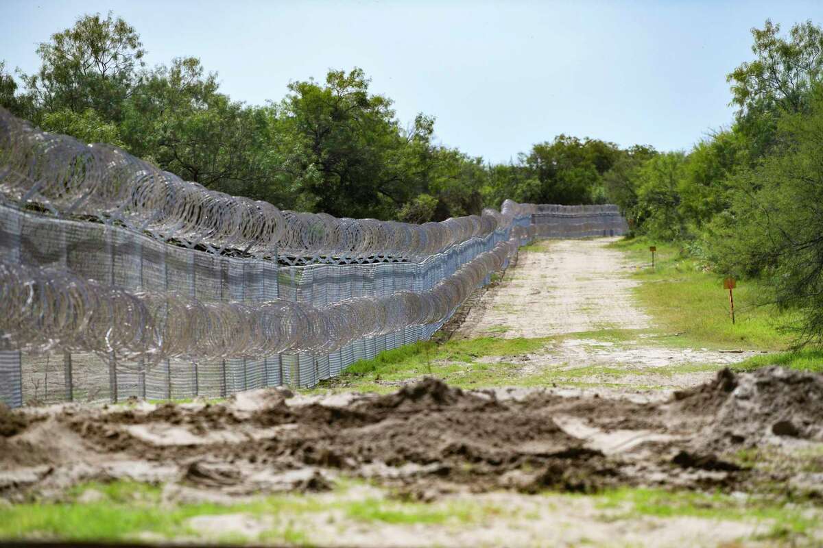 The "Abbott fence," made of chain link and concertina wire, has been placed along the border at Del Rio, Texas, on Wednesday, July 28, 2021. Texas Gov. Greg Abbott has sent the Texas National Guard and Department of Public Safety troopers to stop the migration.