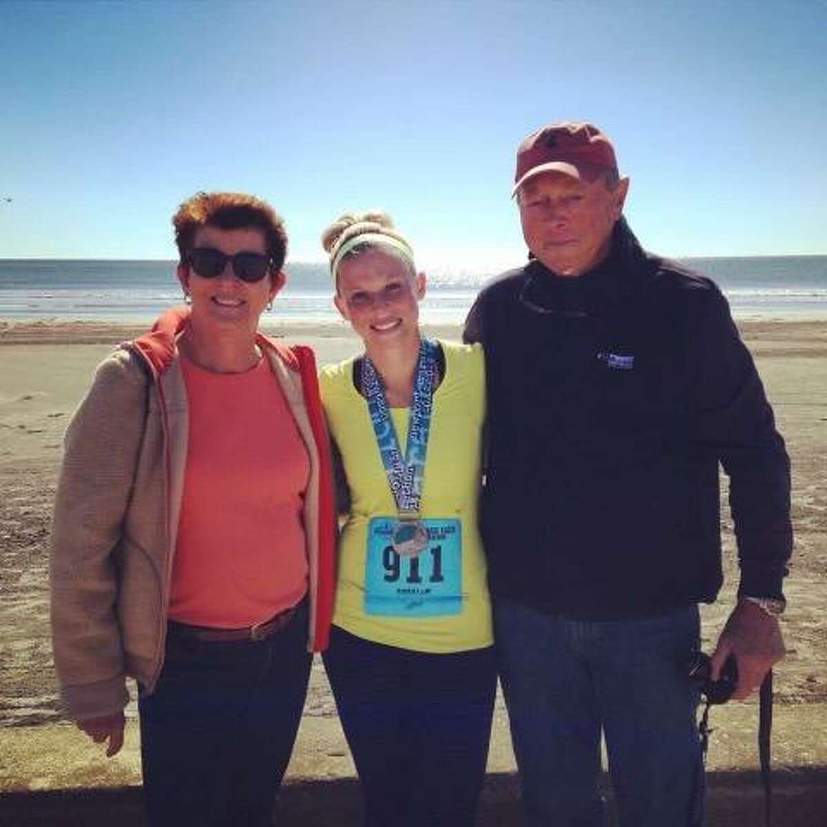Lea Aruilio, center, with her mother Cindy Swanson and father Eric Swanson at the 2014 Newport Marathon.