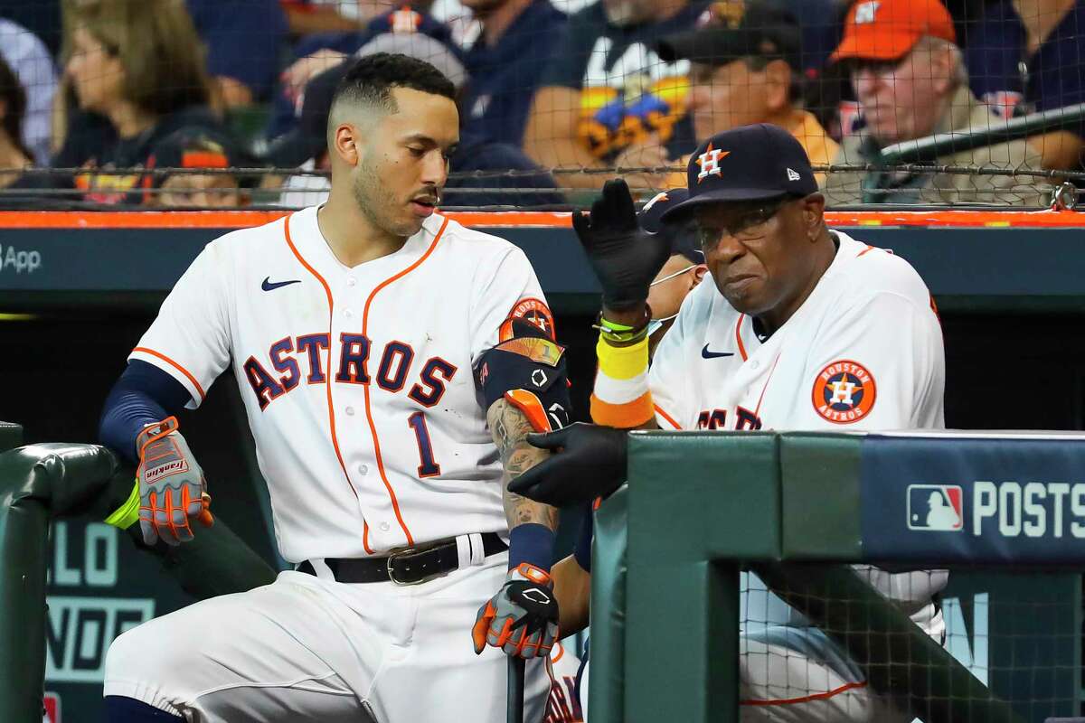 Houston Astros shortstop Carlos Correa (1) talks with Houston Astros manager Dusty Baker Jr. (12) during the sixth inning in Game 1 of the AL Division Series Thursday, Oct. 7, 2021, in Houston.