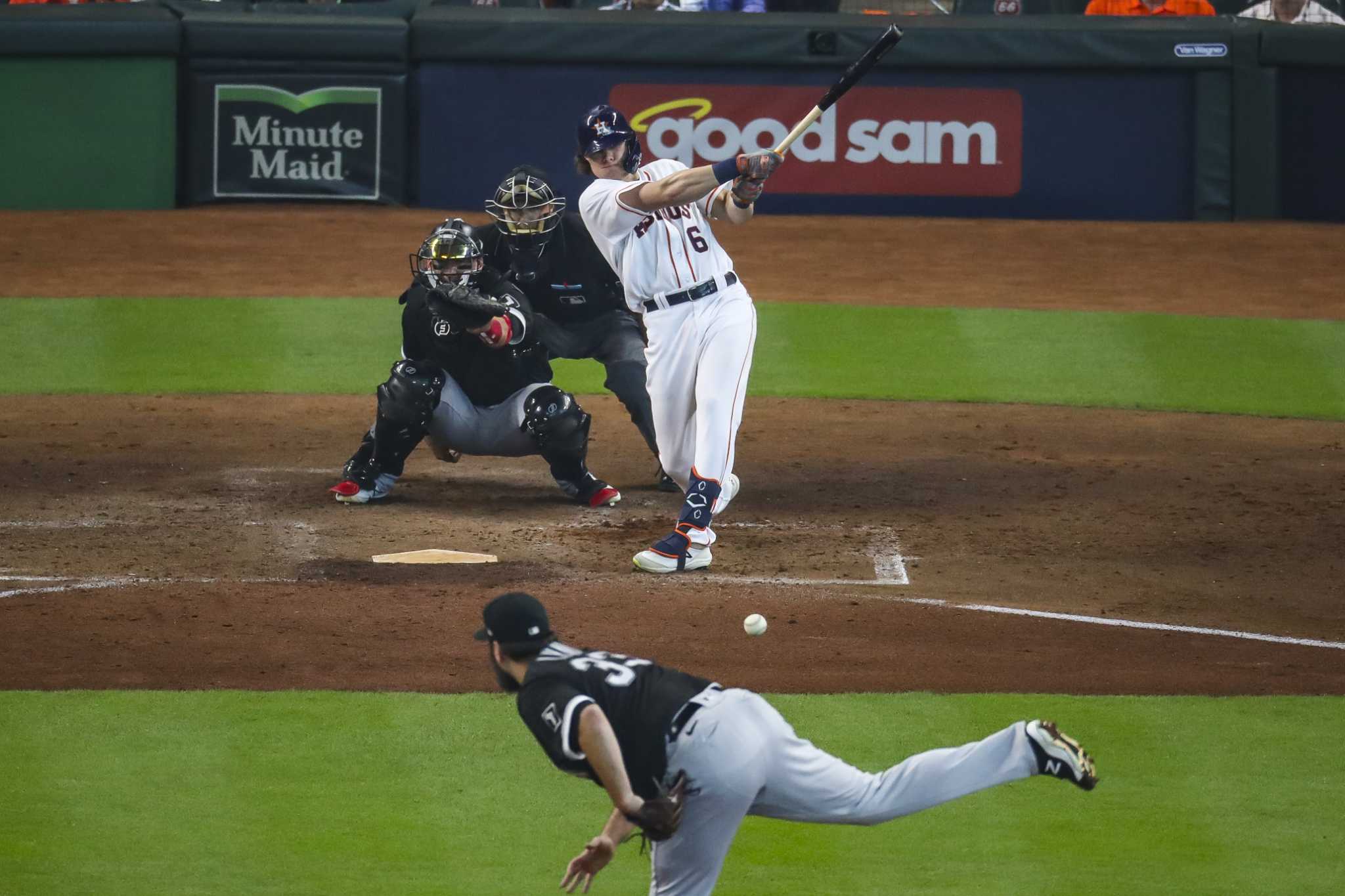 Houston Astros' Carlos Correa (1) low-fives Alex Bregman after Bregman  scored his second run of a baseball game on a sacrifice fly by Yordan  Alvarez during the sixth inning against the Seattle