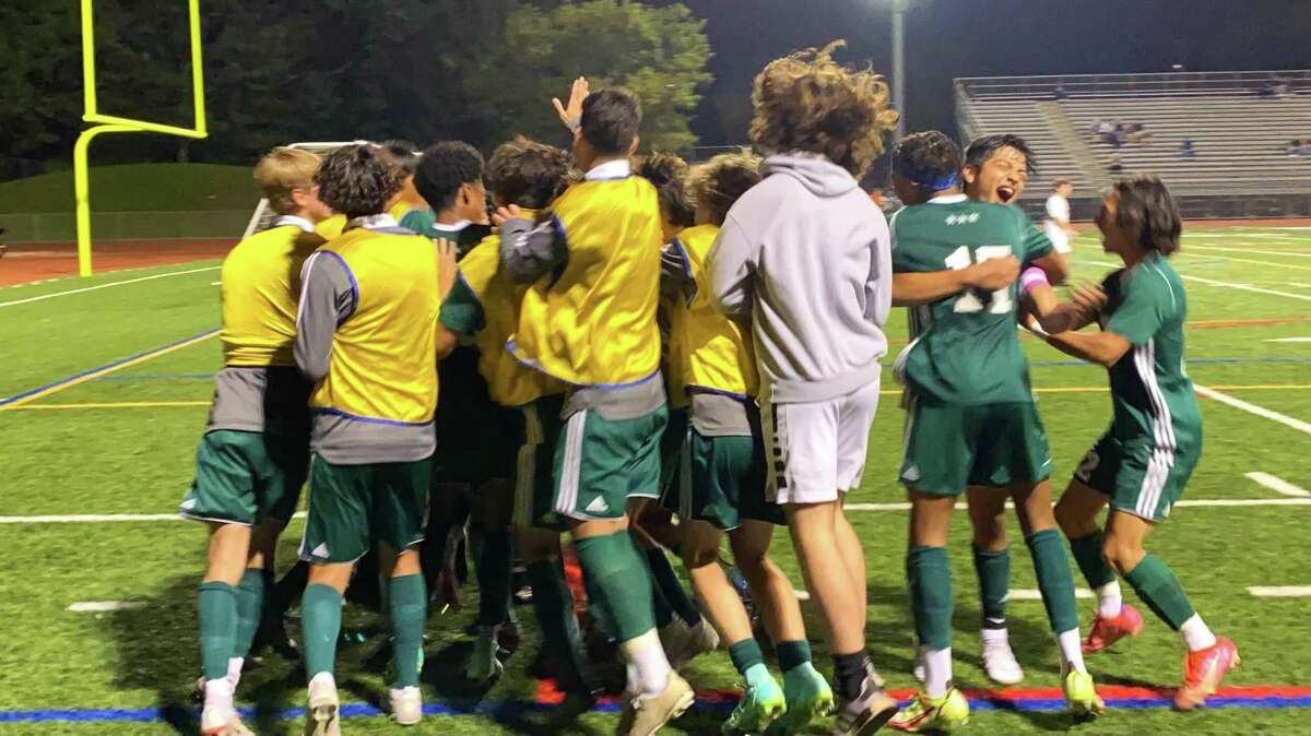 Members of the Norwalk boys soccer team celebrate their win over Warde Thursday, Oct. 7, 2021.