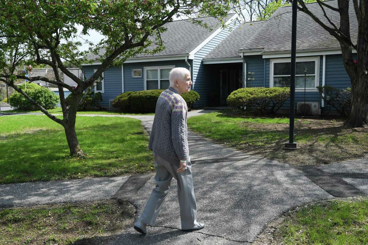 Brooks Quarry resident Barbara Locke walks to her apartment in the Brookfield affordable housing complex on May 2, 2019.
