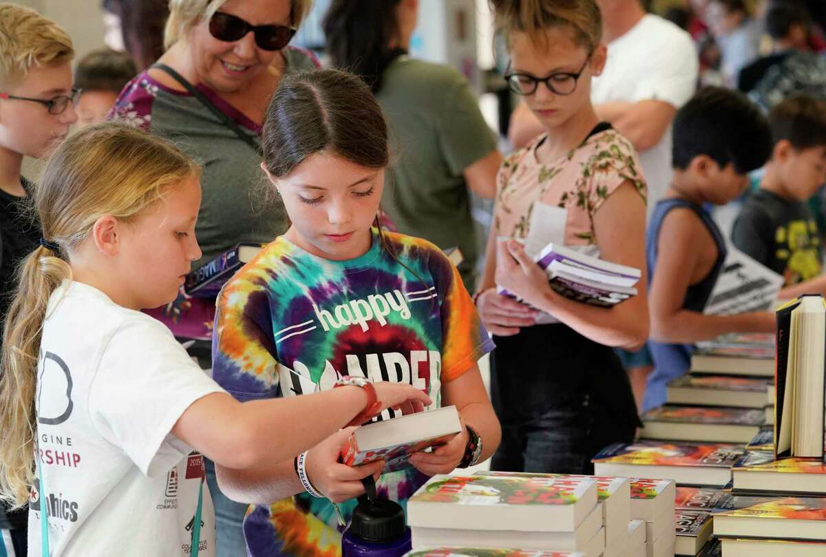 Evelyn Ibarra, 10, left, and Luci Pennings, 10, right, both fifth graders at Meadows Elementary in Ft. Bend ISD look at books during the Tweens Read Book Festival held at Pasadena Memorial High School, Saturday, Oct. 19, 2019, in Pasadena.