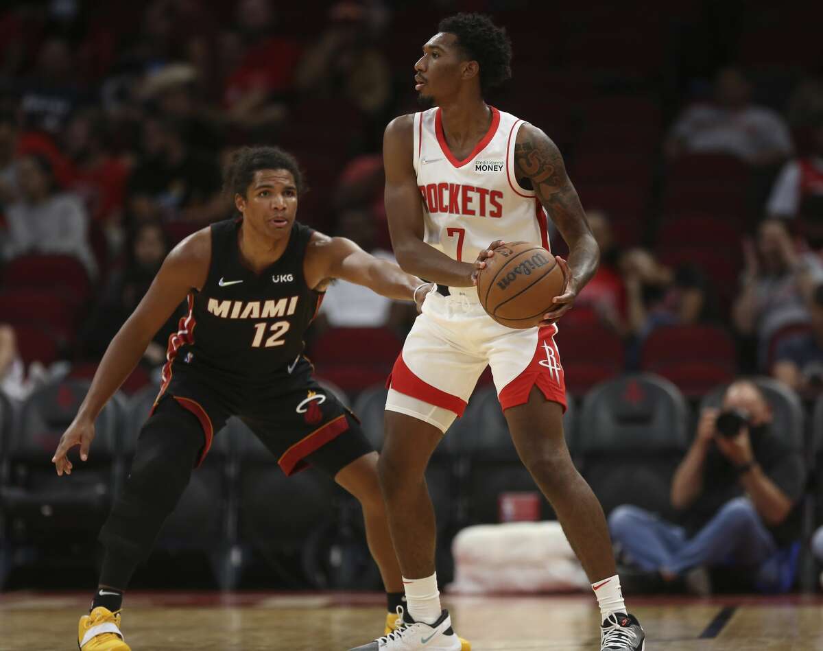 Houston Rockets guard Armoni Brooks (7) looks for a pass while Miami Heat guard Dru Smith (12) is guarding during the fourth quarter of a NBA preseason game Thursday, Oct. 7, 2021, at Toyota Center in Houston. The Rockets lost to the Heat 106-113.