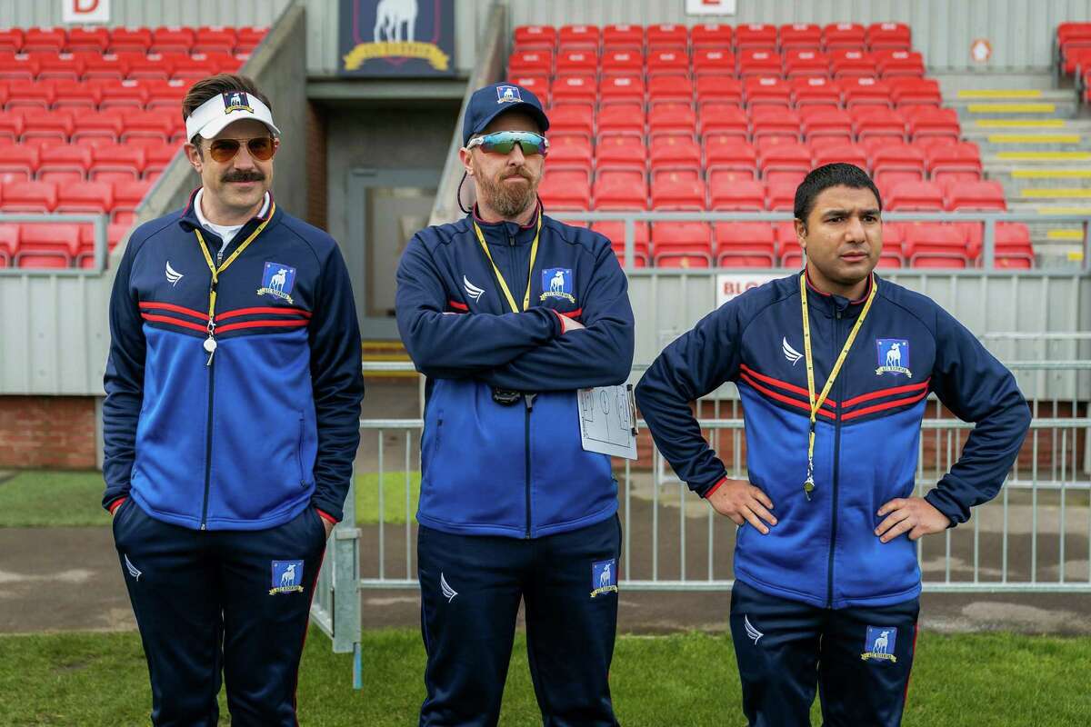 The character of Ted Lasso, left (played by Jason Sudeikis pictured here with Brendan Hunt and Nick Mohammed). Lasso is a coach who doesn’t care about winning (or knows anything about soccer), but by uplifting others, and seeing their best, he wins. It is the “Lasso way.” Why should this be a fairy tale? Why can’t this be real life?