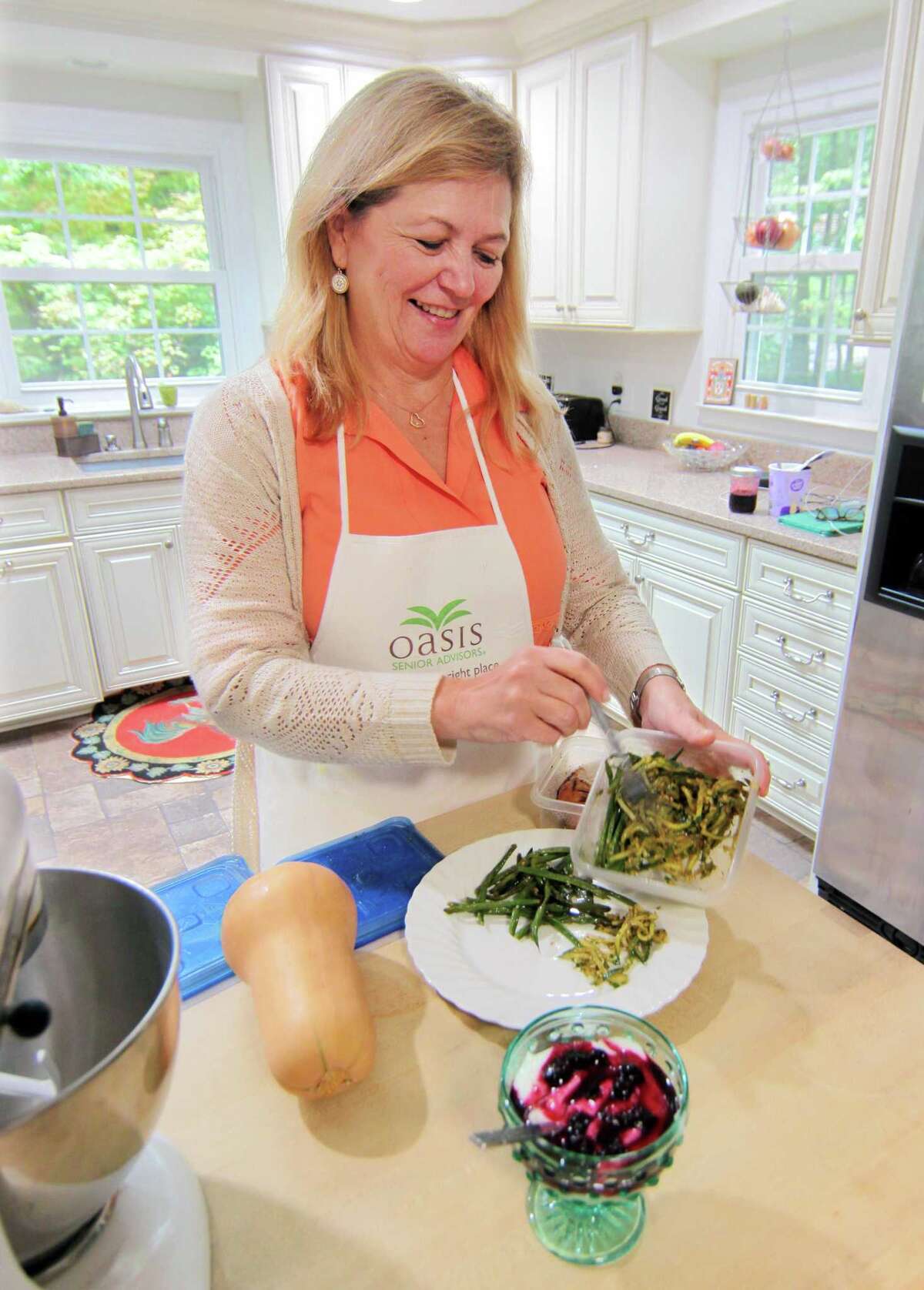 Susan Doyle, who uses Zoom to broadcast her show: Downsized Gourmet, poses in her kitchen at her home in Stamford, Conn., on Tuesday October 5, 2021. Due to the COVID-19 pandemic, in June of 2020 Susan and her husband Paul, who takes care of all things tech related, started the cooking show and invited members of several senior centers and facilities to tune in. Their work has culminated in a cookbook which will raise money for the Fairfield County Walk to End Alzheimer's slated for Sunday October 10th.