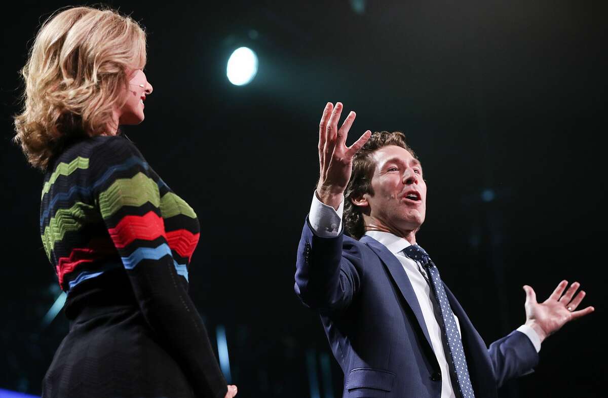 Minister Joel Osteen talks to attendees at "A Night of Hope" with his wife, Vicoria on Saturday, Oct. 28, 2017, in Los Angeles.