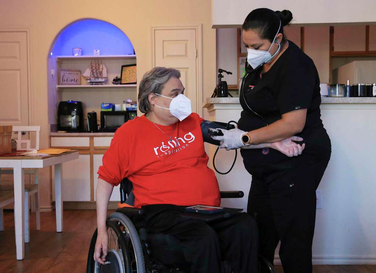 Nurse Yolanda Torres checks the vitals for Chris Salas.