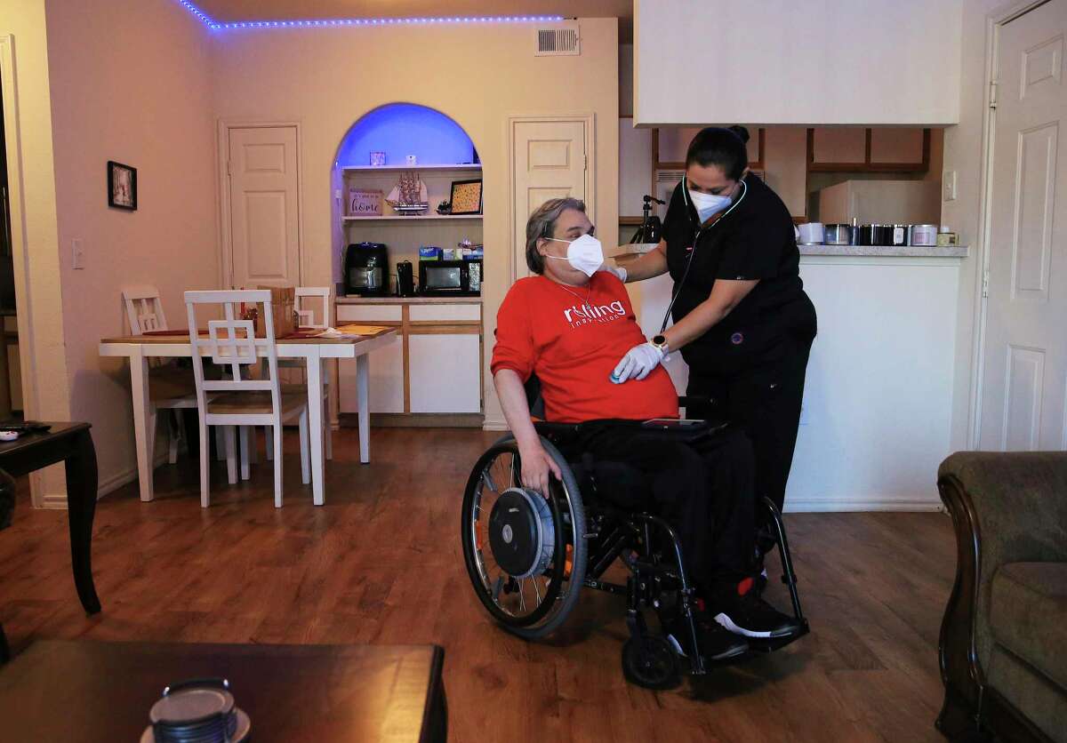 Nurse Yolanda Torres checks the vitals for Chris Salas. After being paralyzed in a car accident in 1997, Salas founded Rolling Inspiration, a local nonprofit with a goal of “helping all people with mobility impairments.”