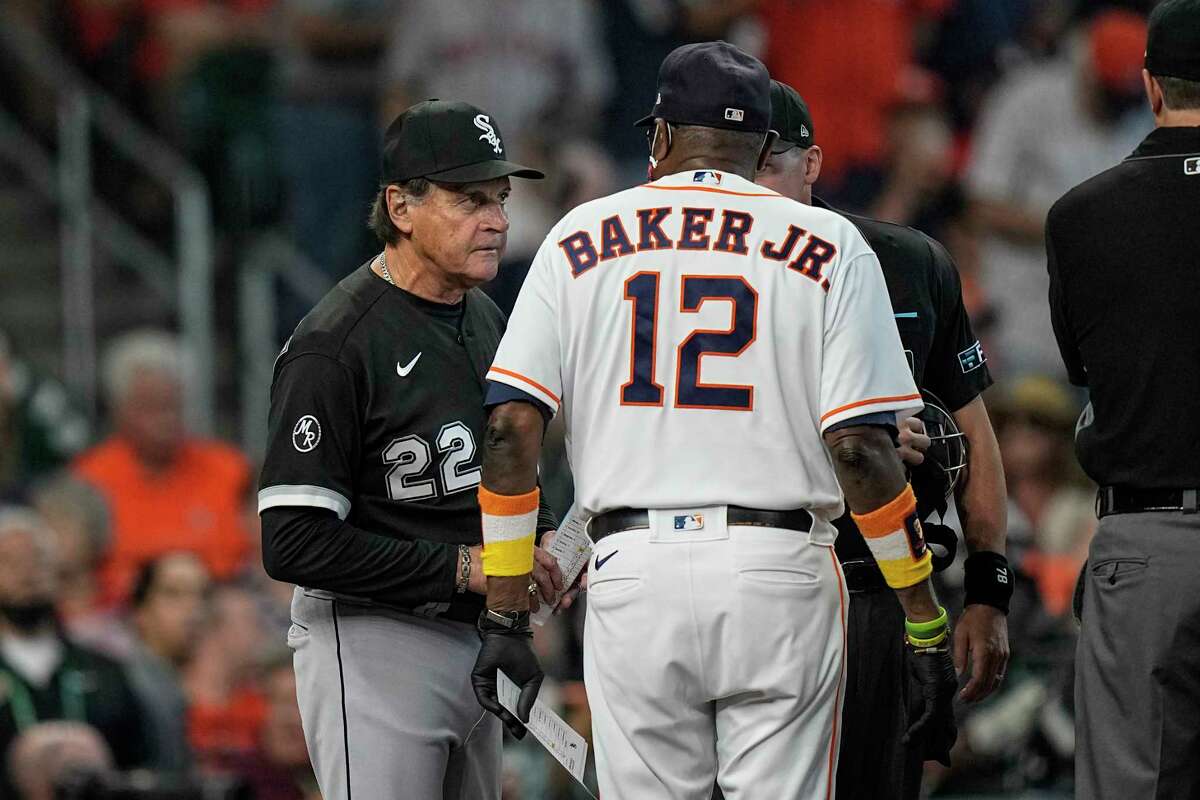 Chicago White Sox manager Tony La Russa (22) meets with Houston Astros manager Dusty Baker Jr. (12) and umpires at home plate prior to Game 1 of a baseball American League Division Series Thursday, Oct. 7, 2021, in Houston. (AP Photo/David J. Phillip)