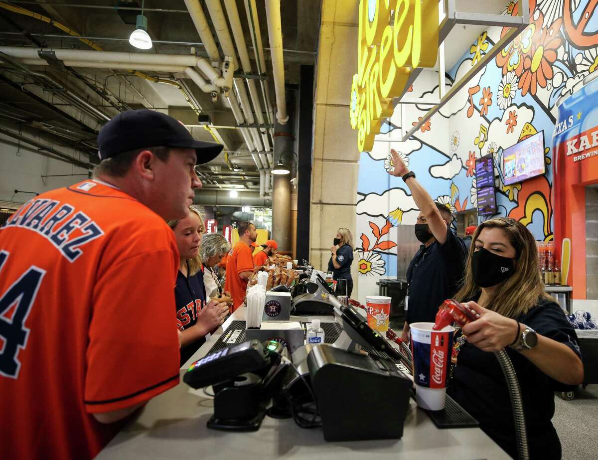 Yvette Soliz puts a soft drink for a customer before game 2 of the American League Division Series between the Houston Astros and the Chicago White Sox at Minute Maid Park on Friday, Oct. 8, 2021, in Houston.