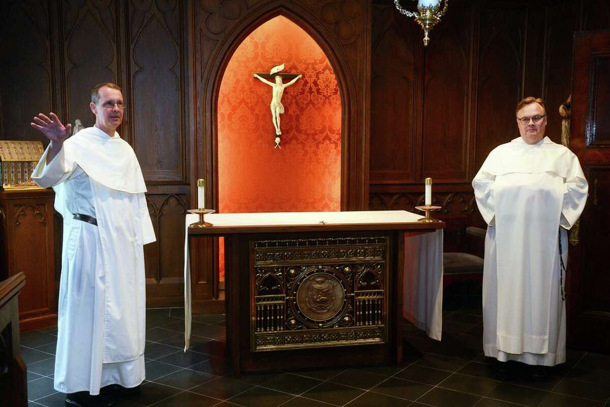 Reverend John Paul Walker, left, and Reverend Jordan Lenaghan stand during an interview in the chapel inside the priory of St. Mary's Church in New Haven, Connecticut on October 7, 2021. Walker and Lenaghan are Dominican brothers and live in the priory.