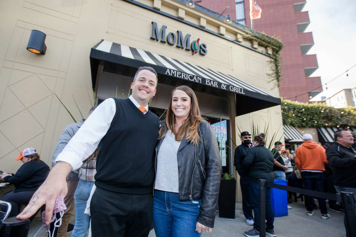 MoMo's owner Scott Morton poses with his wife Caitlyn outside their sports bar and restaurant, which sits across the street from Oracle Park in San Francisco.