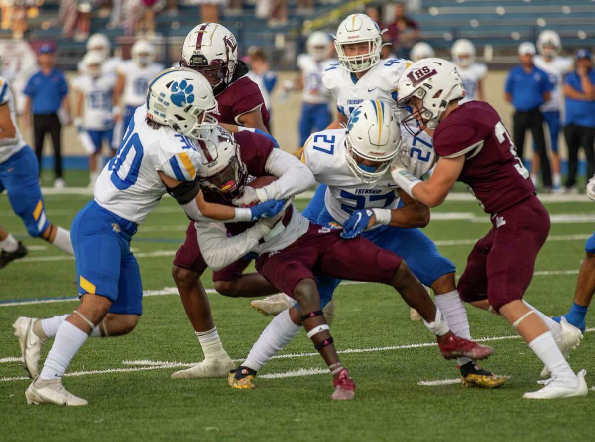 Legacy’s Addison Akbar is brought down by Frenship’s Marcelo Fernandez (30) and Jeremiah Washington (27) on Friday, Oct. 8, 2021 at Grande Communications Stadium. Jacy Lewis/Reporter-Telegram