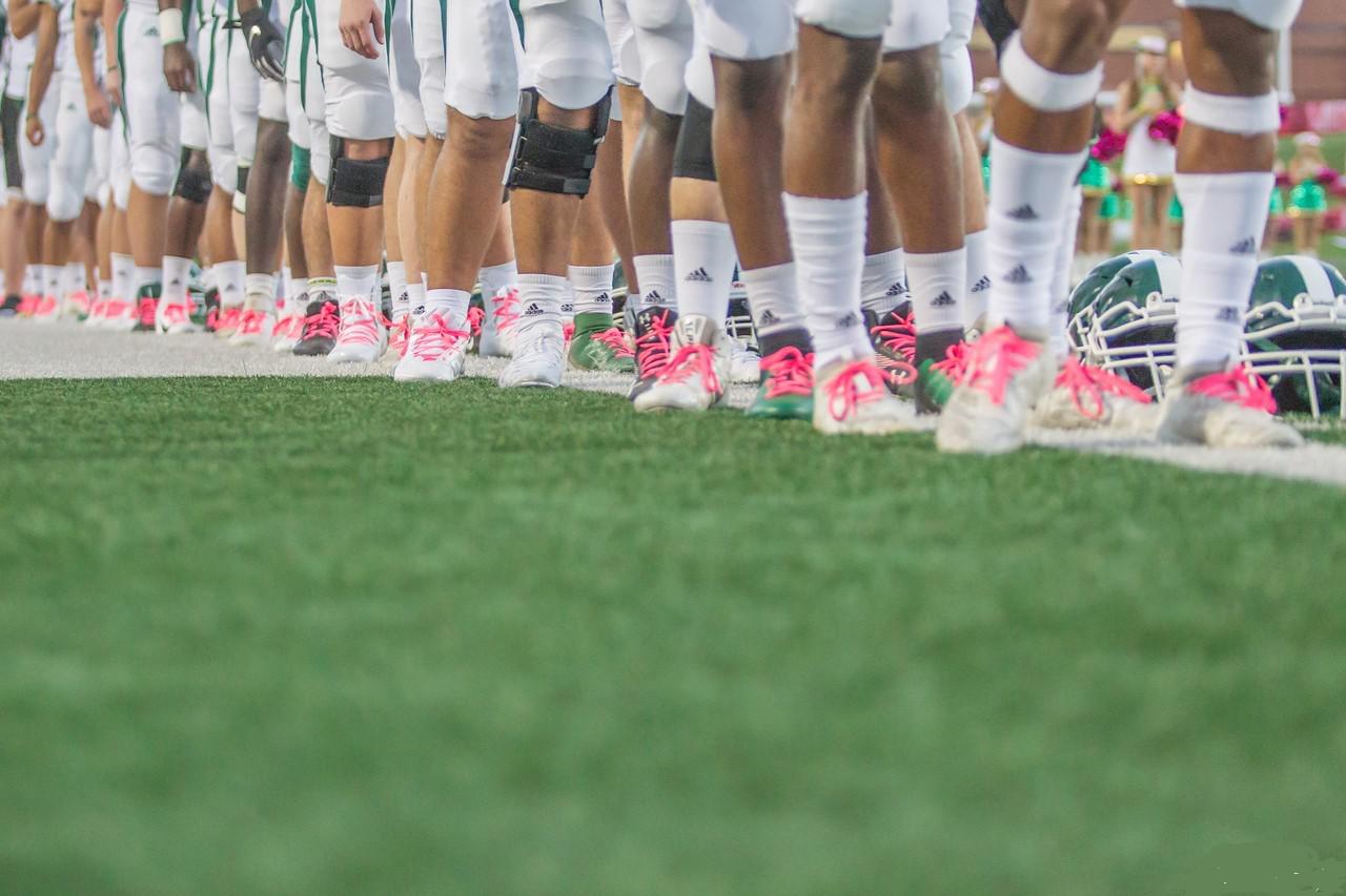 High school athletes support breast cancer awareness with pink