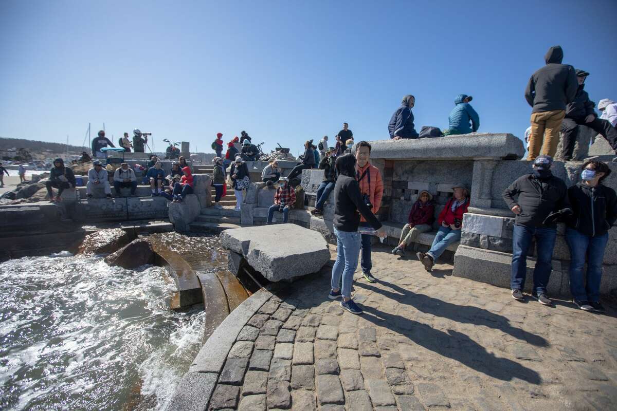 People sit on the Wave Organ in San Francisco on Oct. 8, 2021.