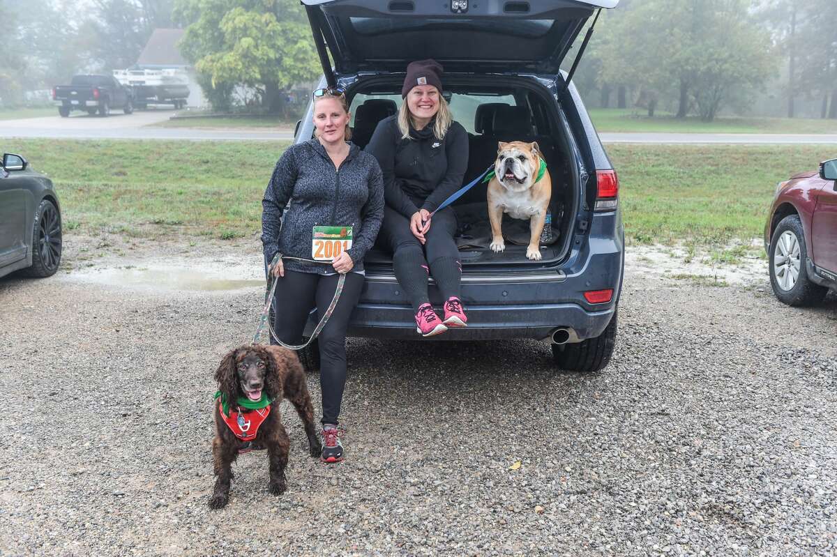 Jessica Heath and Max sit with Ashley Baker and Charlie preparing to run during the Great Lakes Bay Animal Society's 9th annual Fast & Furriest 5K Run/Walk at Midland City Forest on Oct. 9th, 2021 (Adam Ferman/for the Daily News)
