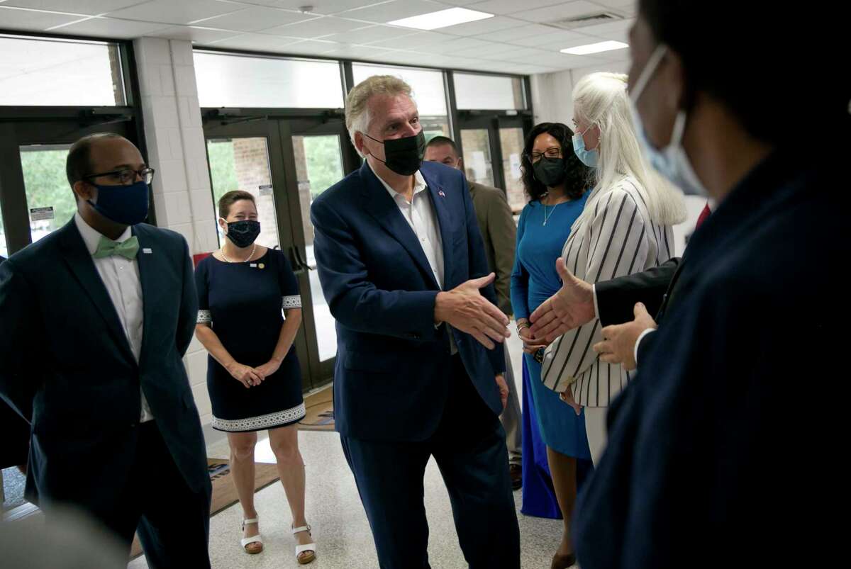 Virginia Democratic gubernatorial candidate Terry McAuliffe meets faculty members during a visit to New Horizons Regional Education Center in Hampton, Va., on Oct. 7.