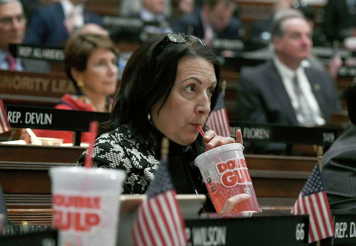 FILE - In this Feb. 20, 2019 file photo, state Rep. Anne Dauphinais R-Killingly, takes a sip from a big gulp soda as Connecticut Democrat Gov. Ned Lamont delivers his budget address at the State Capitol in Hartford, Conn. (AP Photo/Jessica Hill, File)