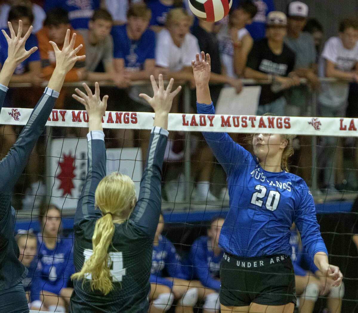 Midland Christian's Carley King tries to tip the ball away from Liberty Christian's Jadyn Fife and Kaley Janusek 10/09/2021 at McGraw Event Center. Tim Fischer/Reporter-Telegram