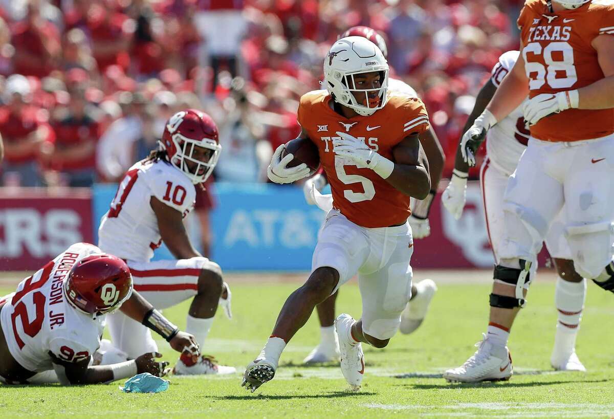 Bijan Robinson #5 of the Texas Longhorns rushes the ball in the second quarter against the Oklahoma Sooners during the 2021 AT&T Red River Showdown at Cotton Bowl on Oct. 9, 2021 in Dallas.