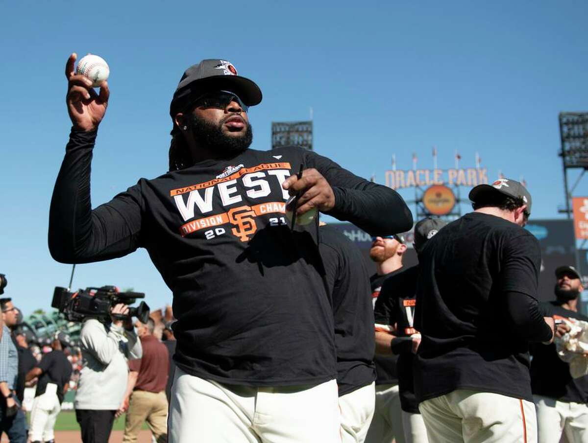 SAN FRANCISCO, CALIFORNIA - OCTOBER 03: Johnny Cueto #47 of the San Francisco Giants signs a baseball and throws to the crowd after a game against the San Diego Padres at Oracle Park on October 03, 2021 in San Francisco, California. (Photo by Brandon Vallance/Getty Images)