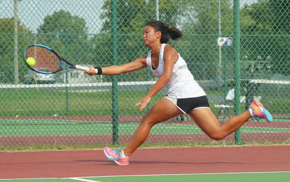 Edwardsville’s Chloe Koons runs down a shot during her No. 1 singles final in the Southwestern Conference Tournament at O’Fallon.